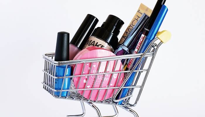 Imagem de carrinho de compras em miniatura com cosméticos dentro, representando como editar página de produtos