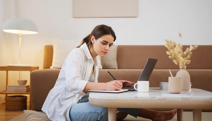 6 melhores cursos online gratuitos do SEBRAE para quem quer montar um e-commerce Mulher estuda em frente a computador, representando os cursos online gratuitos do Sebrae