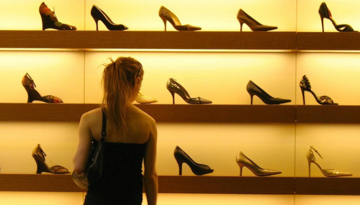 A influência do Facebook e do YouTube na tomada de decisão de compra em um e-commerce Mulher tomando decisão de compra em frente a vitrine de sapatos