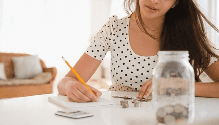 Una mujer anota en su libreta los tips de finanzas para emprendedores.
