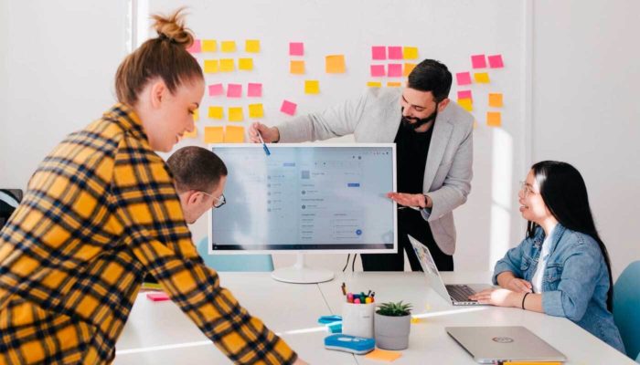 Aprenda como fazer a gestão de vendas da sua empresa Pessoas reunidas em um escritório trabalhando em gestão de vendas