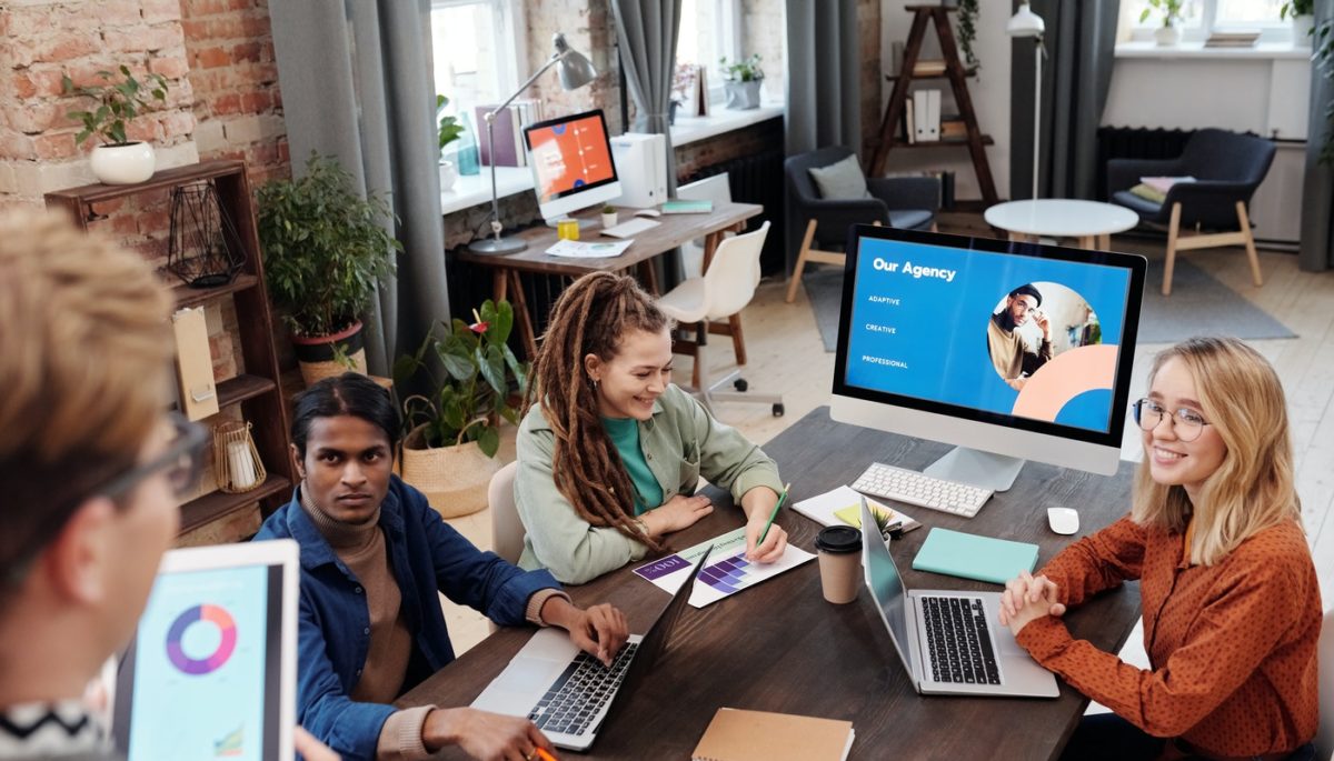 Vale a pena trabalhar com consultoria de marketing digital? Na imagem, vemos um grupo de pessoas em uma empresa conversando
