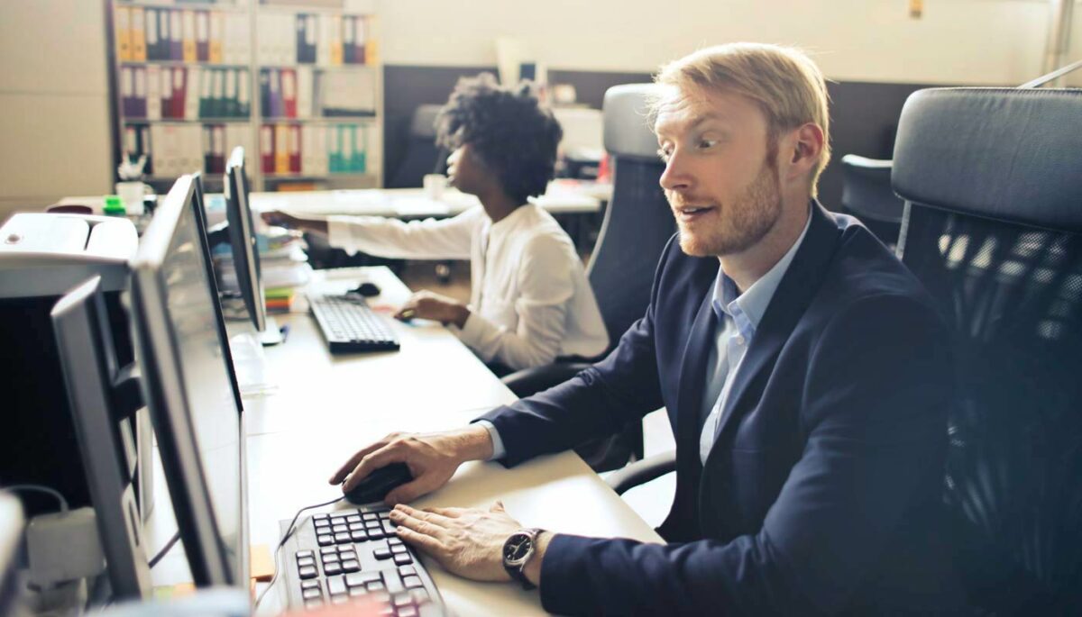 Qual o CNAE para dropshipping e como regularizar seu CNPJ Homem surpreso diante da tela do computador descobre qual o CNAE para dropshipping
