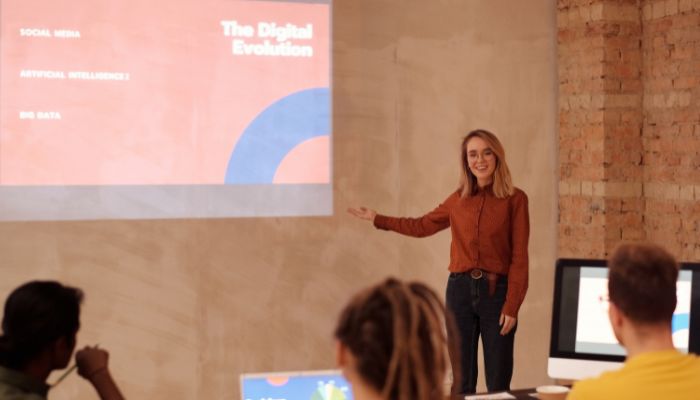 Mujer utilizando un formato de presentaciones digitales para dar una charla empresarial