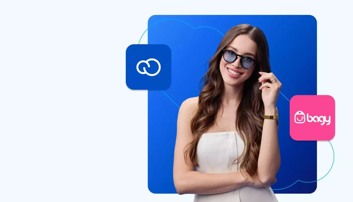 Bagy ou Nuvemshop: qual a melhor? Números e comparativos Jovem empreendedora posa para foto. Ao fundo, vemos o logo da Nuvemshop e da Bagy, ilustrando o comparativo entre as plataformas.